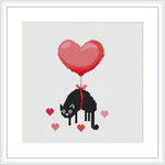 The design displays a black cat with a red ribbon around its neck. The ribbon extends upwards into a large, heart-shaped balloon above the cat. Around the cat, smaller hearts are scattered, suggesting a love theme.