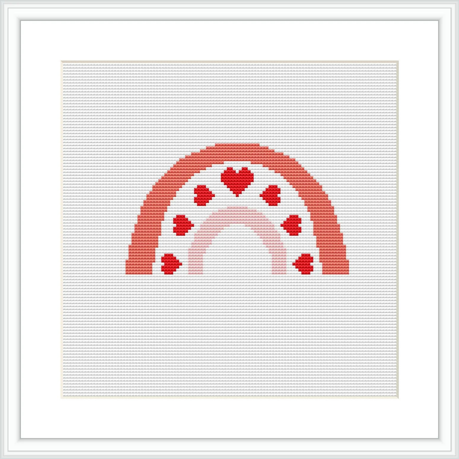 The image features a cross stitch pattern of a partial rainbow with hearts embedded within it. The design is framed and displayed against a white backdrop.