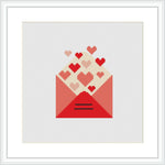 The image features a cross stitch pattern depicting an envelope in shades of red, with a variety of hearts in red and pink tones appearing to float out of it. The envelope is centered on a white background, and it is framed with a simple white border.