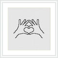 The image shows a framed cross stitch pattern depicting two hands forming a heart shape in the center. The stitches are made in a single color on a plain white canvas.
