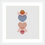 The image shows a framed cross stitch pattern consisting of three stacked abstract hearts. Each heart consists of horizontal stripes in various colors, with a solid colored circle in the center. The colors alternate between blue and red for the stripes, with pink and brown for the central circles. The design is centered on a white canvas within a square frame.