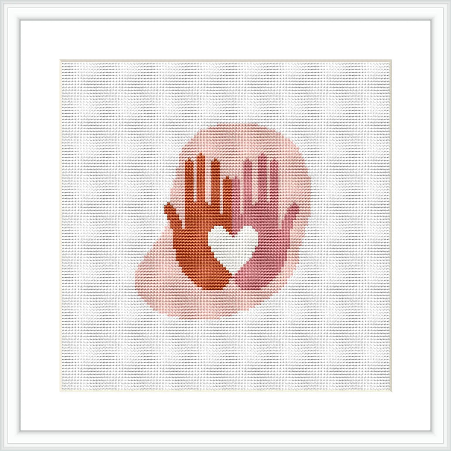 The image displays a framed cross stitch pattern depicting a silhouette of two hands forming a heart shape. The stitches create a gradient effect from reds at the bottom to lighter shades at the top, set against a white background.