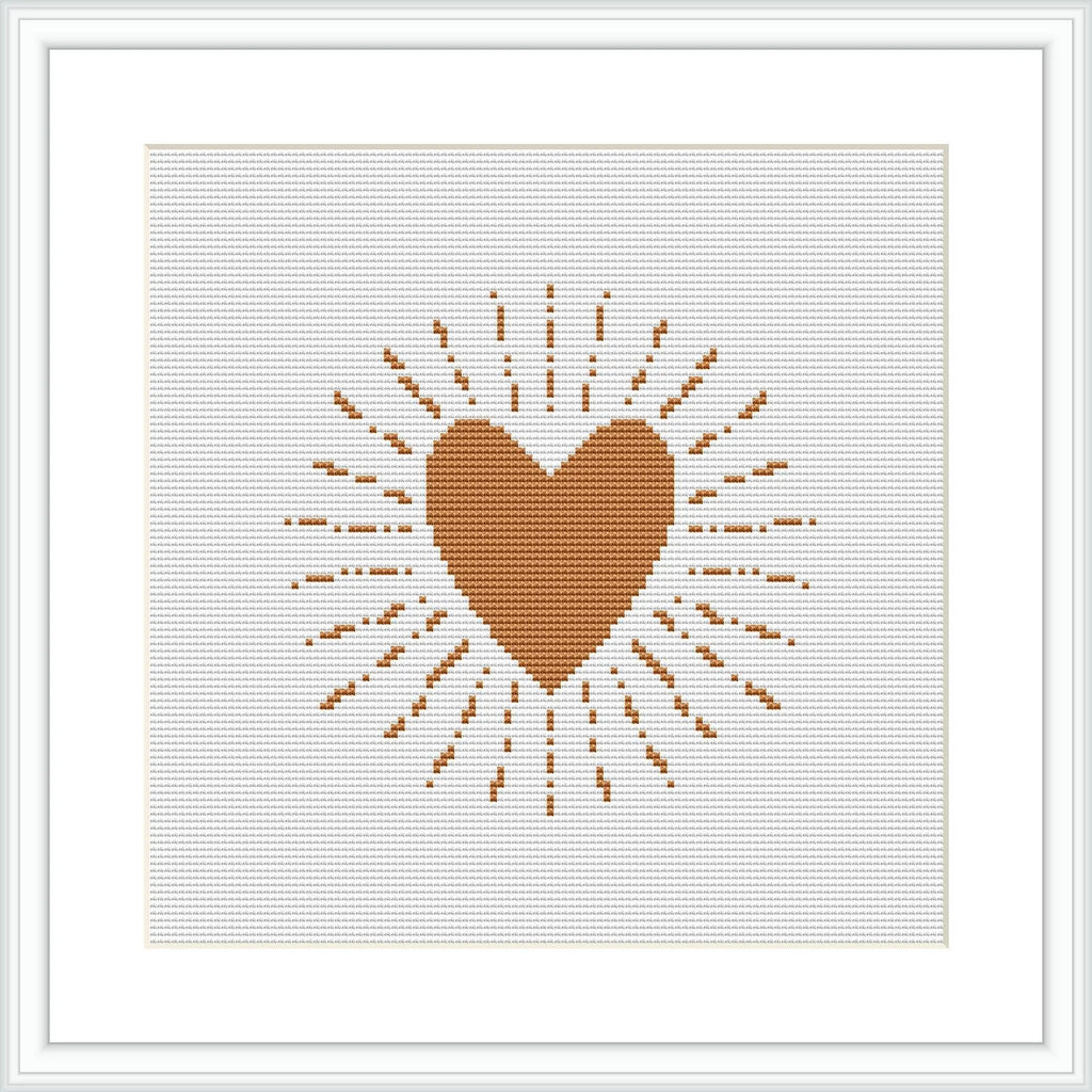 A cross stitch pattern displaying a centered brown heart with radiating lines and dots creating a sunburst effect, displayed on an ivory or white background within a frame.