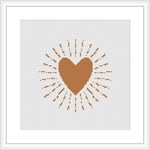 A cross stitch pattern displaying a centered brown heart with radiating lines and dots creating a sunburst effect, displayed on an ivory or white background within a frame.