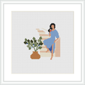 The image features a cross stitch pattern of a seated figure in a blue dress, resting their head on their hand. Beside the figure is a potted plant. The figure is seated on what appears to be a bench, with an abstract beige background.