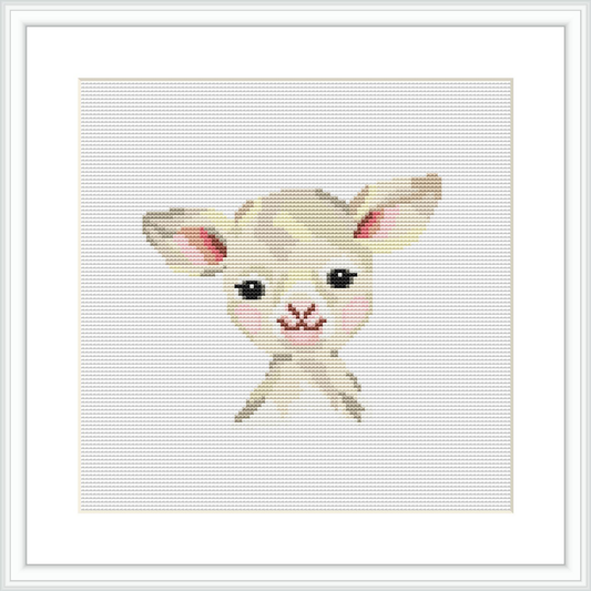 The image displays a framed cross stitch pattern of a young, adorable lamb against a plain white background.