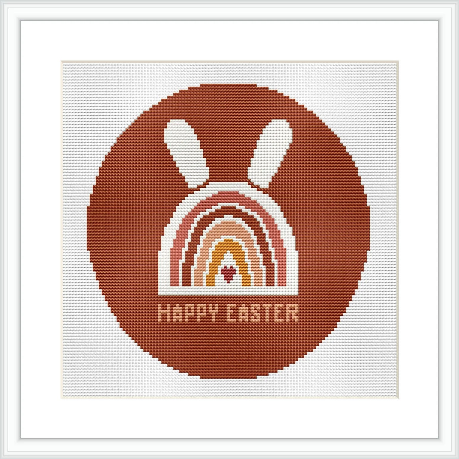 The image displays a framed cross stitch pattern showing a stylized brown bunny above a rainbow arc with the phrase 'HAPPY EASTER' at the bottom, all contained within a circular border.