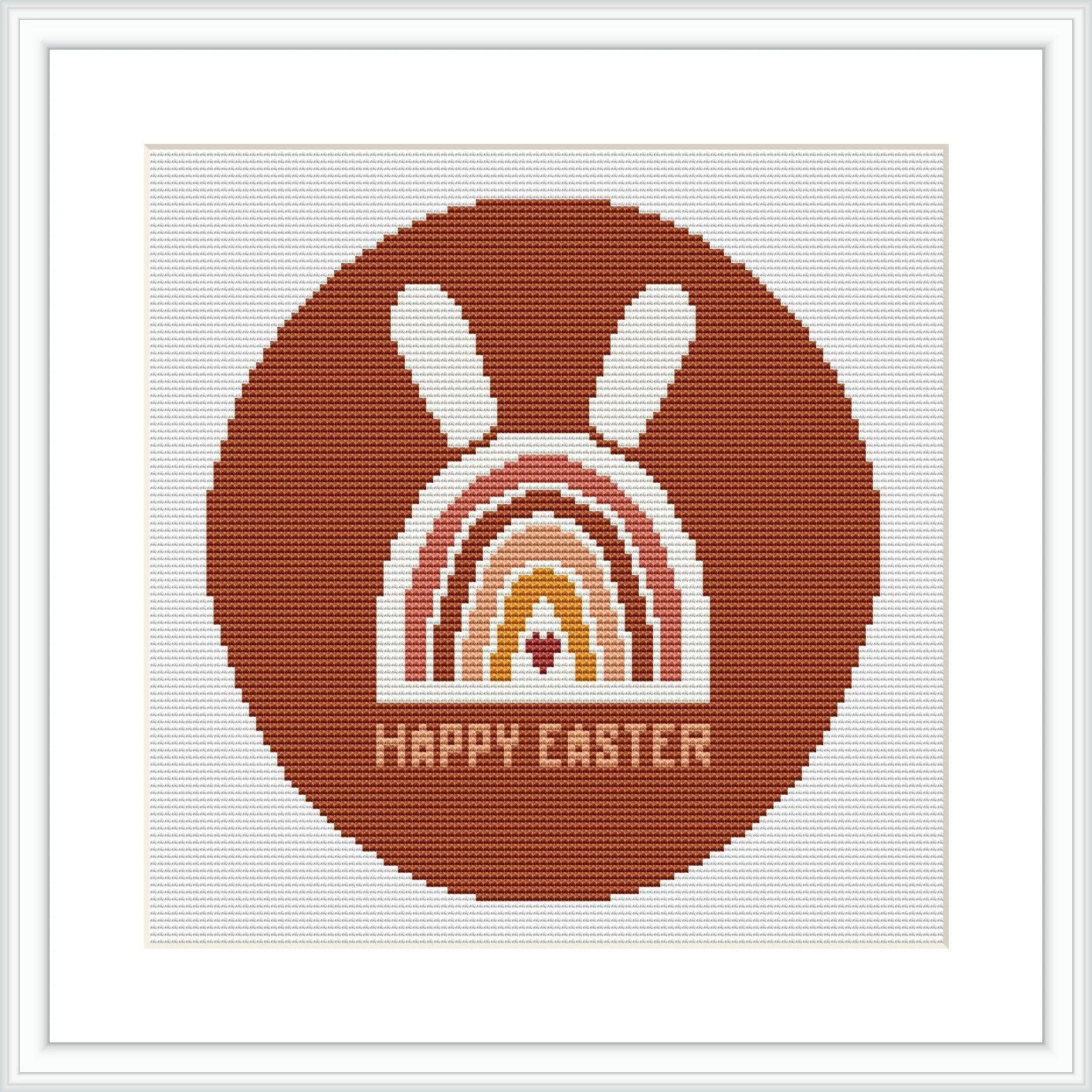 The image displays a framed cross stitch pattern showing a stylized brown bunny above a rainbow arc with the phrase 'HAPPY EASTER' at the bottom, all contained within a circular border.