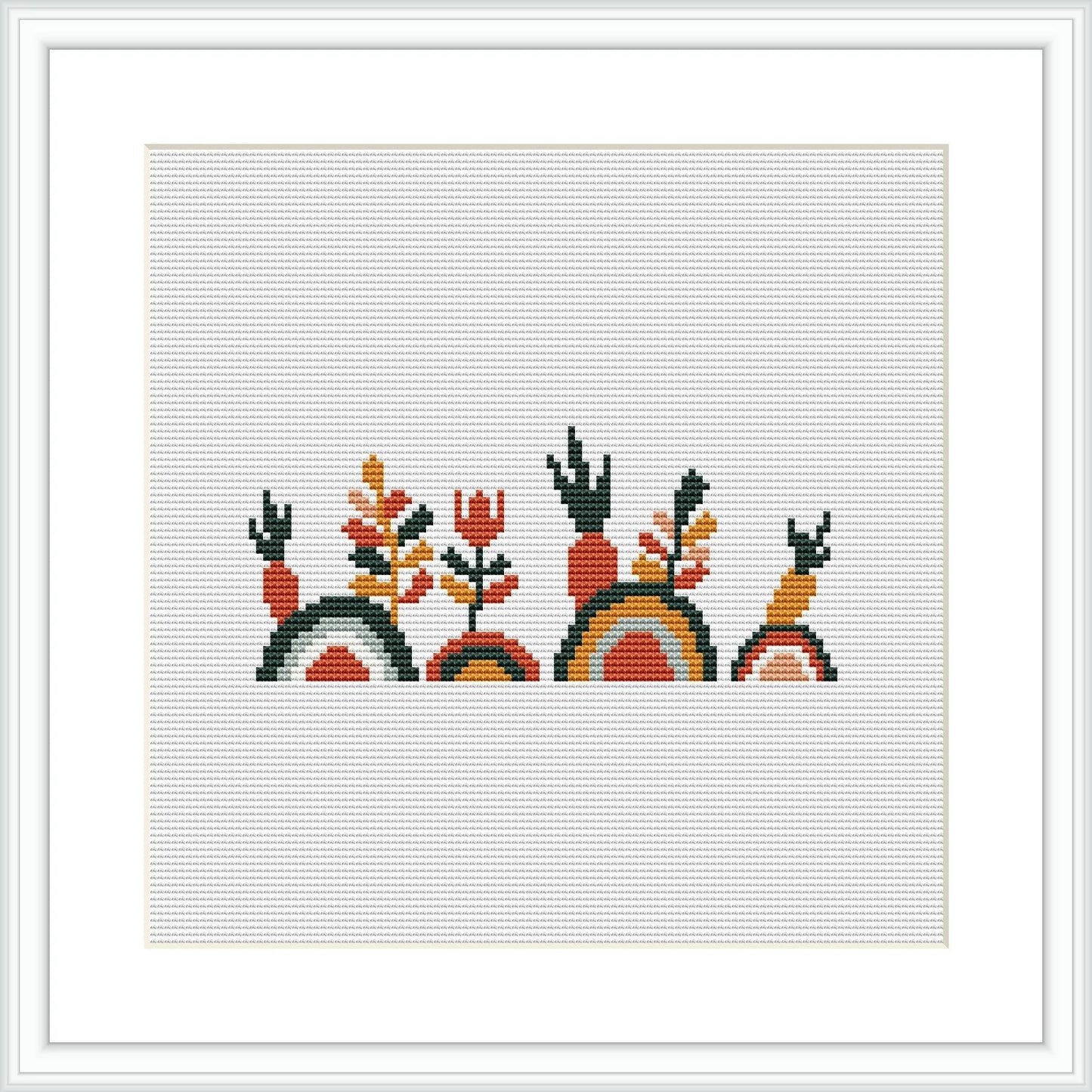 The image shows a framed cross stitch pattern with three stylized bunnies, each sitting on a segment of a rainbow. Flanking the bunnies are two symmetrical floral motifs.