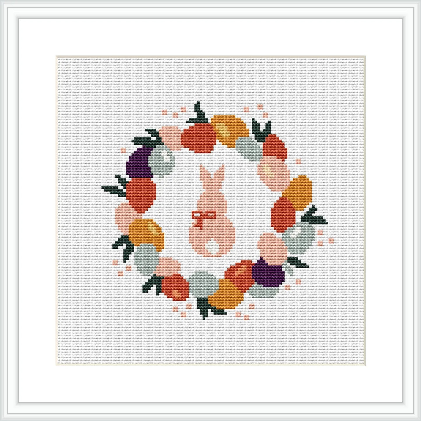 The image shows a cross stitch pattern of a circular wreath composed of colorful Easter eggs and a central rabbit figure. The design is framed within a square, set on a white background.