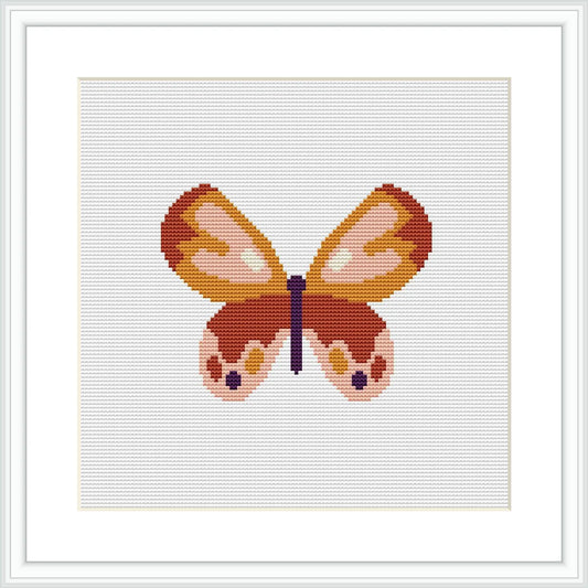 The image shows a framed cross stitch pattern of a stylized butterfly centered on a white canvas, with a color palette consisting of pastel pinks, oranges, yellows, and browns.