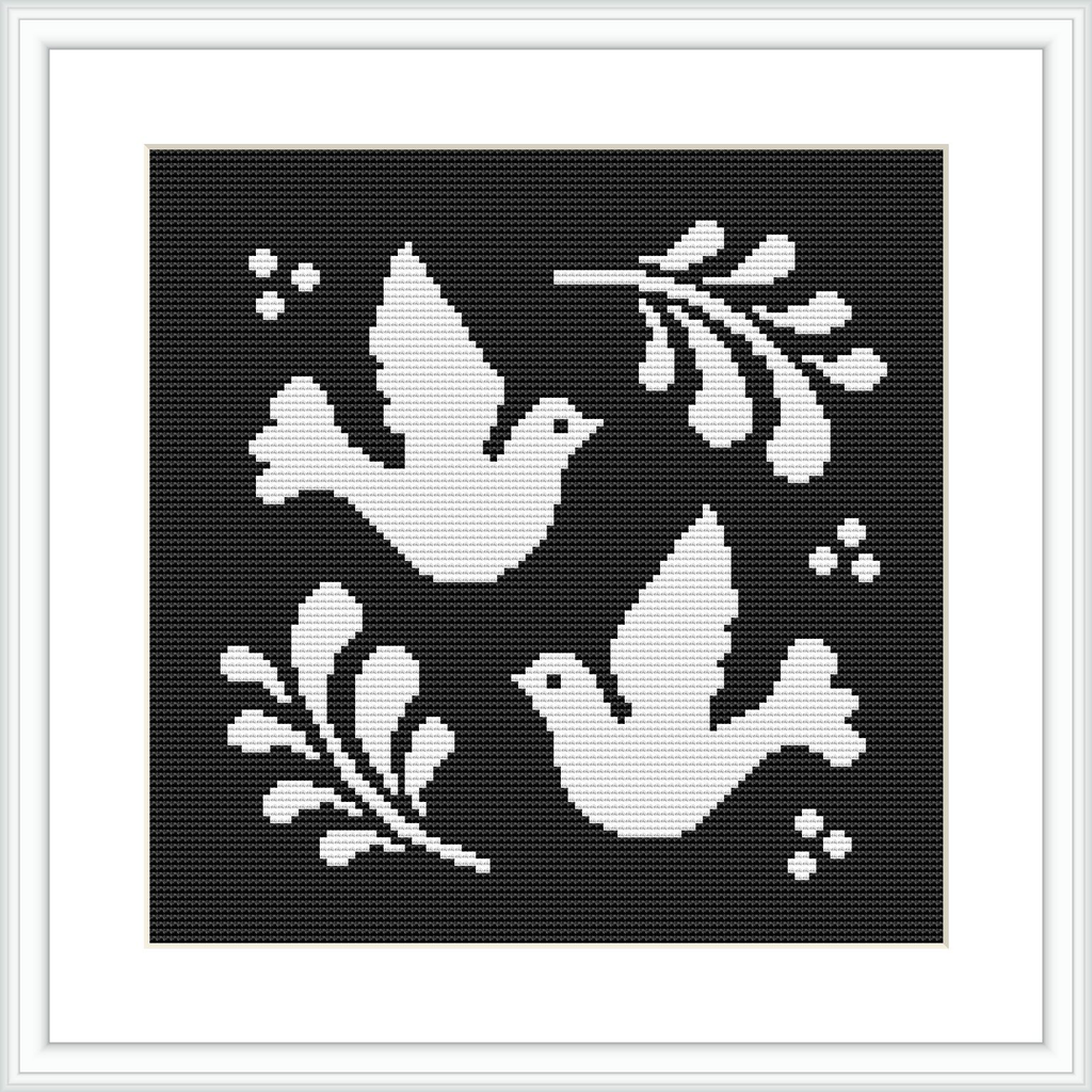The image shows a black and white cross stitch pattern featuring two white doves facing opposite directions. Each dove is accompanied by an olive branch, set against a black background. White border frames the simple yet elegant design.