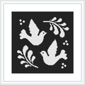 The image shows a black and white cross stitch pattern featuring two white doves facing opposite directions. Each dove is accompanied by an olive branch, set against a black background. White border frames the simple yet elegant design.