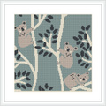 The image features a cross-stitch pattern representing four koalas nestled among patterned eucalyptus branches on a sage green background. The design is bordered by a clean, white frame.