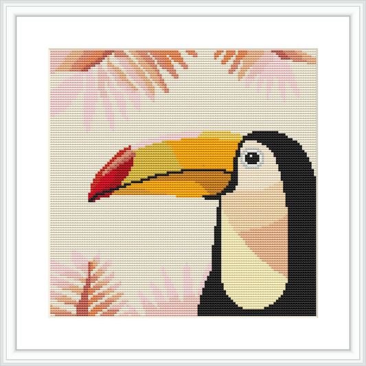 The image presents a cross stitch design of a toucan's profile with its beak pointed to the right. The background consists of stylized foliage in shades of coral and beige, with the entire design framed in white.