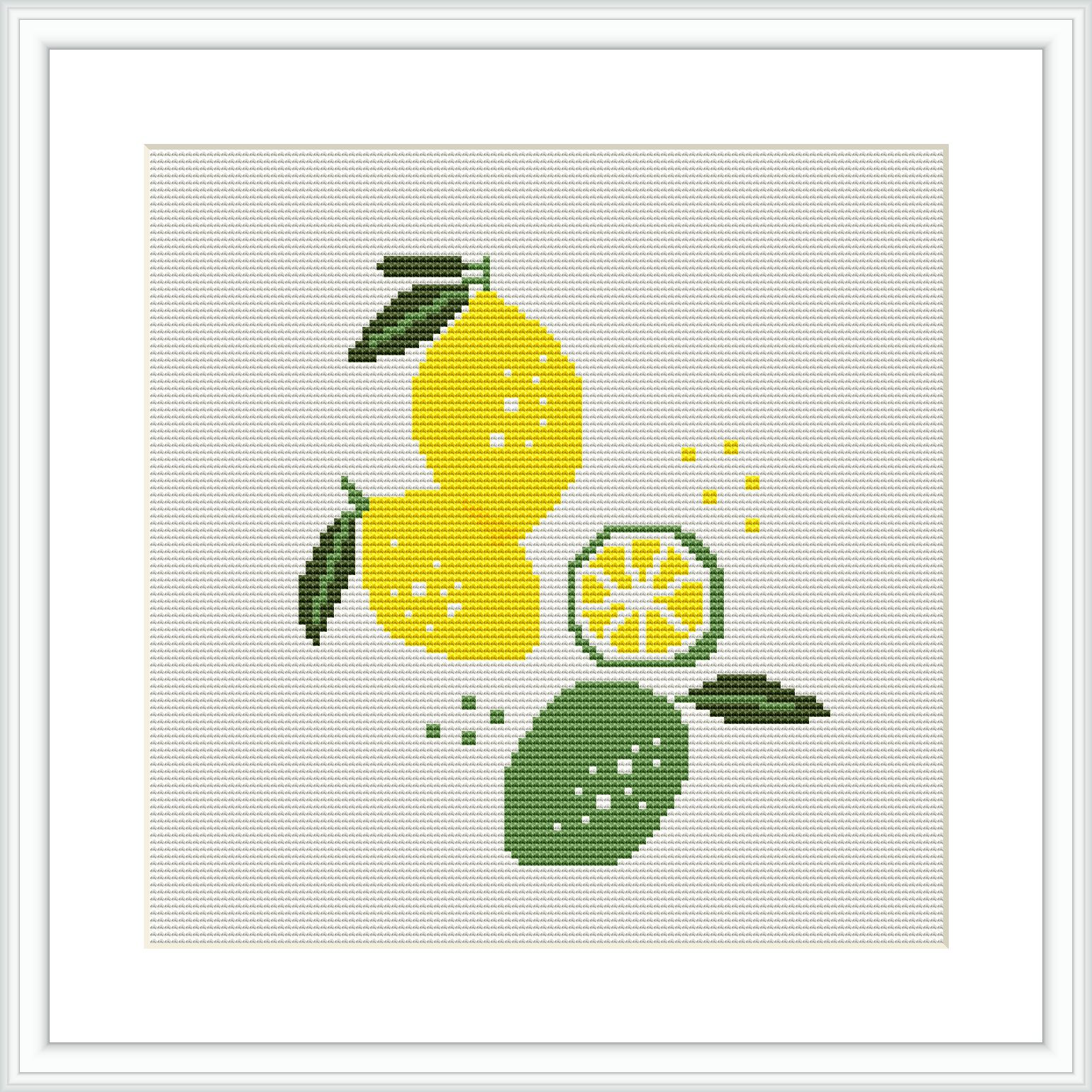 The cross stitch pattern shows a composition of lemons with one of them cut into slices, accompanied by green leaves against a white background. The pattern is framed with a simple flat frame.