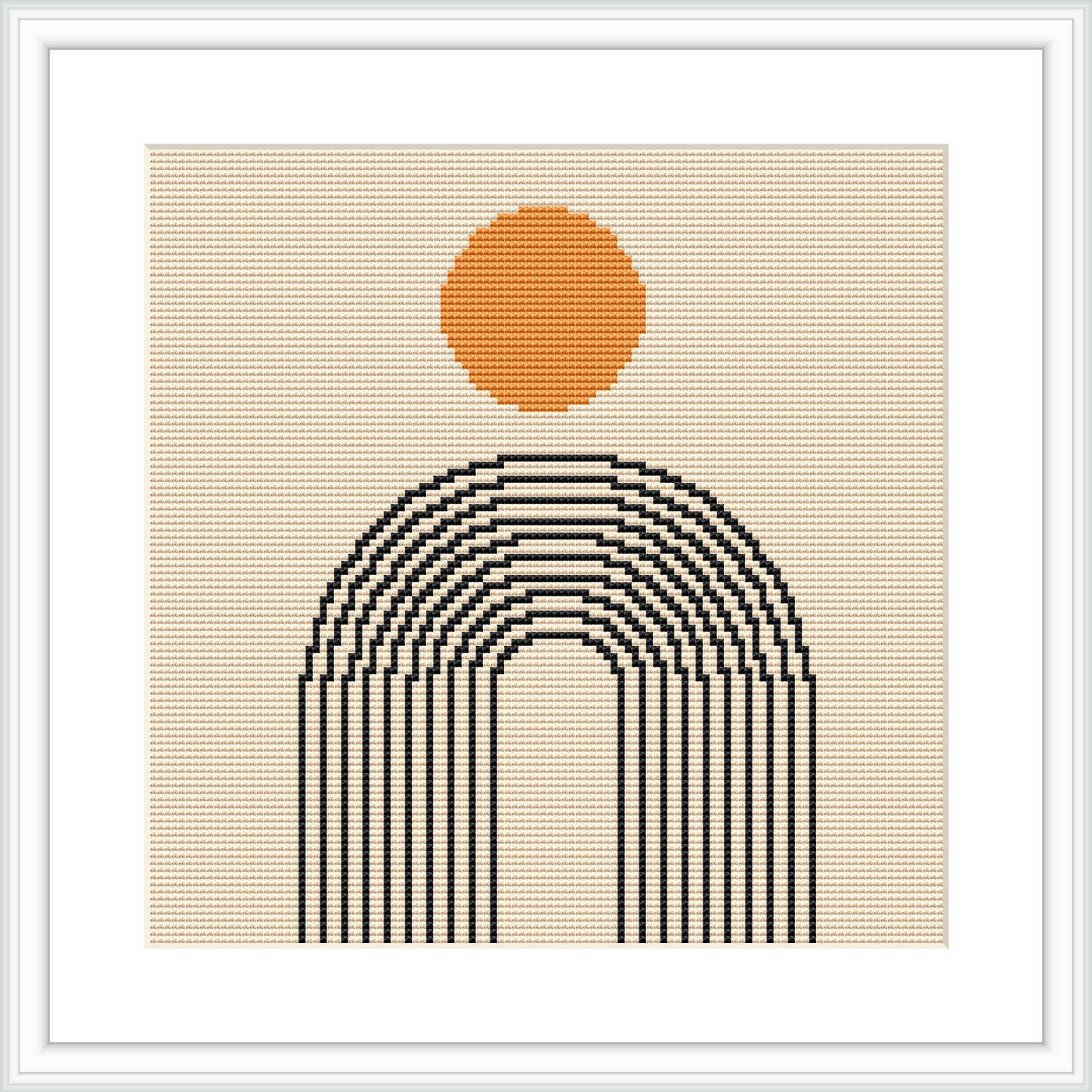 The image shows a framed cross stitch pattern with an orange circular sun centered above curved black lines that form a stylized rainbow, all set against a beige background.