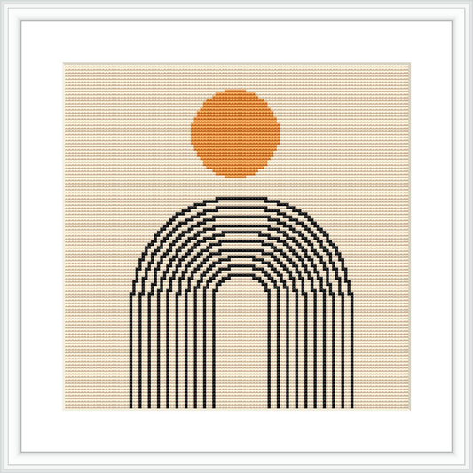 The image shows a framed cross stitch pattern with an orange circular sun centered above curved black lines that form a stylized rainbow, all set against a beige background.