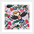 A cross stitch pattern of a colorful toucan surrounded by a lush variety of flowers and leaves. The embroidery is framed and showcases detailed stitching on a white grid-based background.
