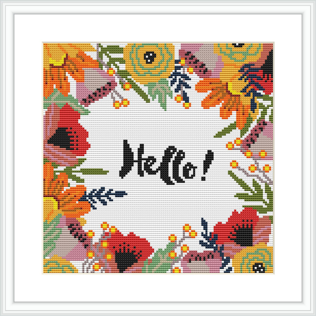 The image shows a framed cross stitch embroidery that features a central text reading 'Hello!' surrounded by a detailed floral pattern with a variety of flowers in shades of yellow, orange, red, and green on a white background.