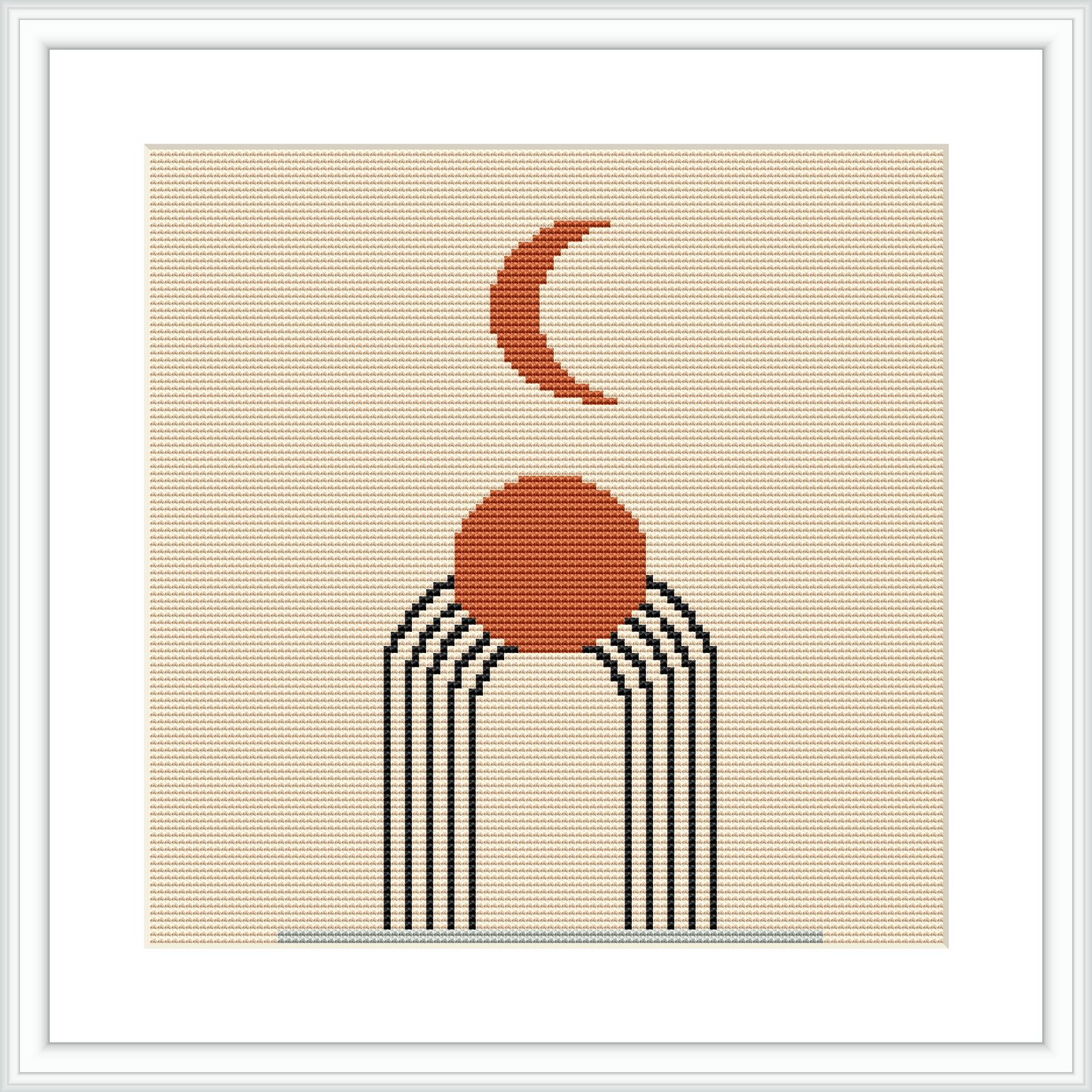 The image features an abstract design depicting a crescent moon above a round sun, both connected by three lines resembling rays or paths. The pattern is centered on a beige aida cloth, and it is framed in a simple white frame.