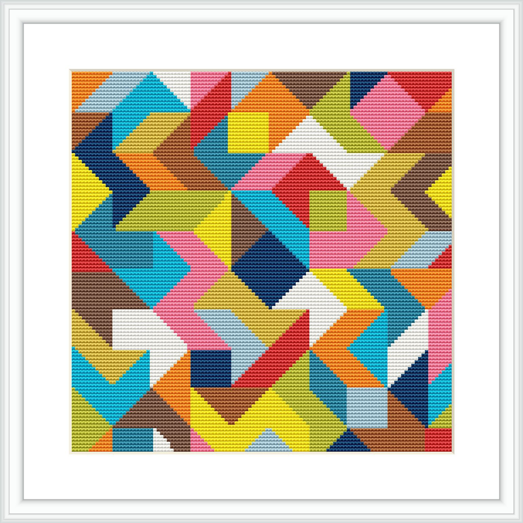 A framed cross stitch with an image showing a pattern of interlocking geometric shapes in multiple colors. The shapes compose a square grid, and the artwork is presented on a white background within a white frame.