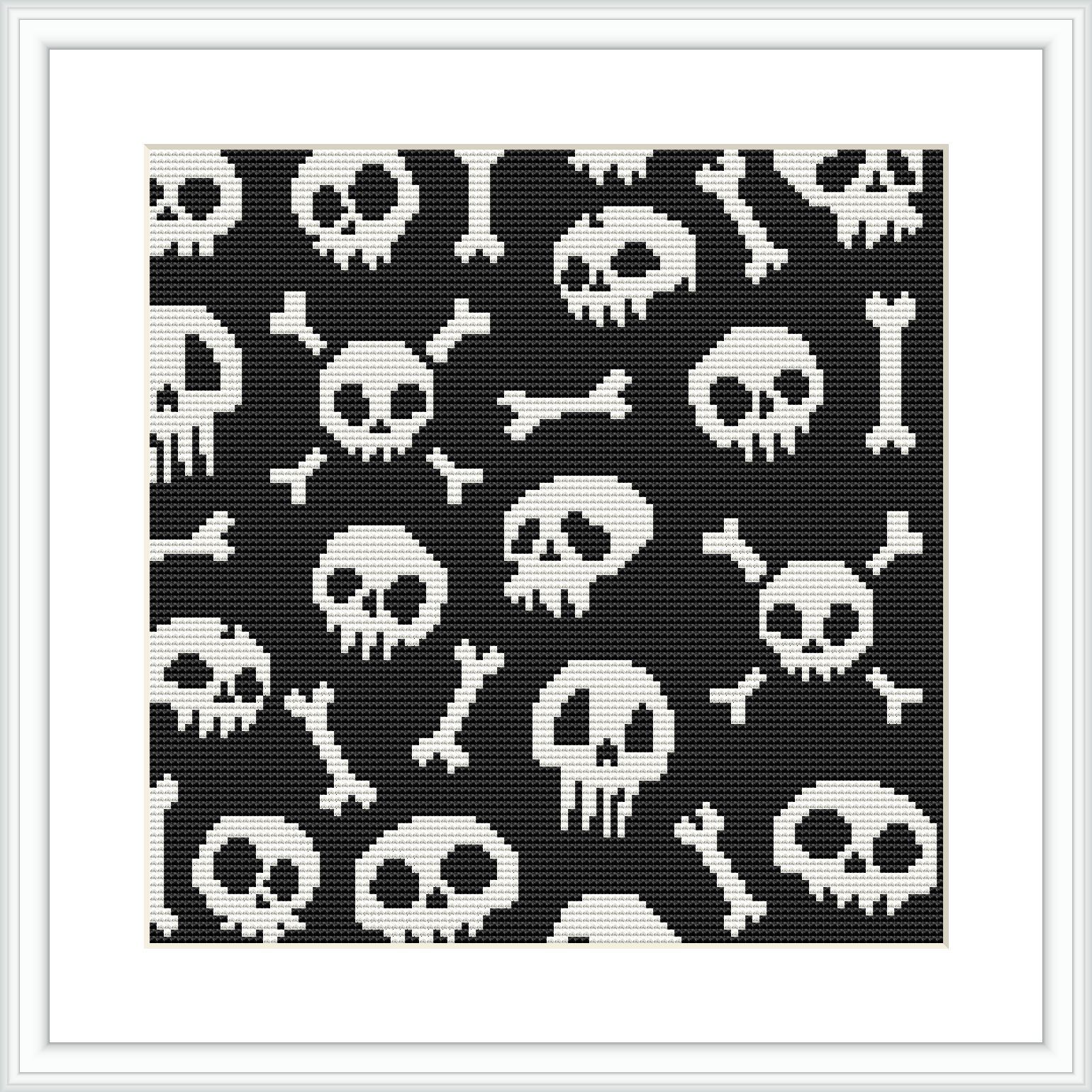 A framed cross stitch pattern depicting various skulls and bones in a monochromatic black-and-white color scheme against a dark background. The design is evenly spaced and features multiple repetitions of the skull and bones motif.