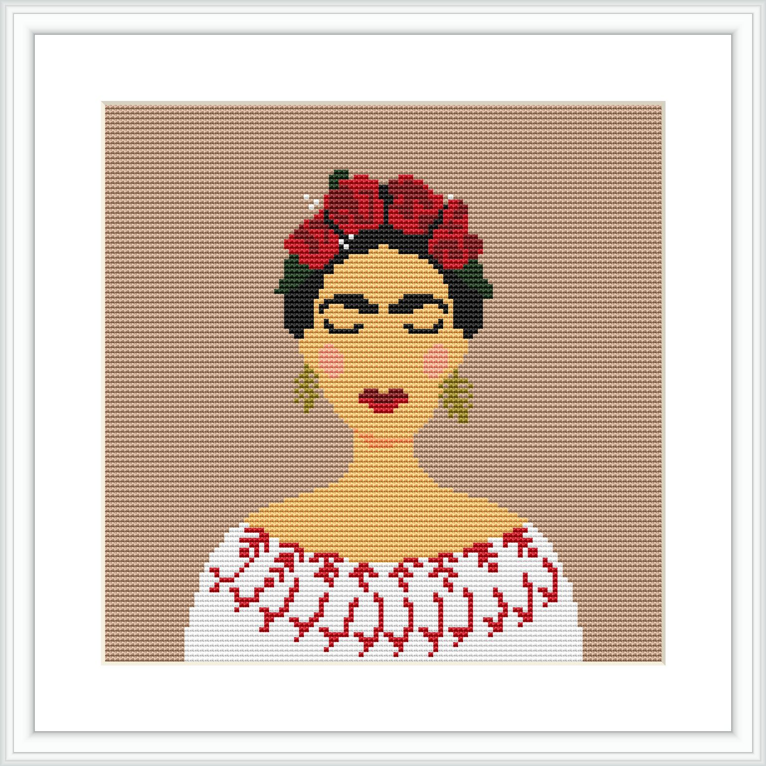 The image shows a cross stitch depiction of a female figure reminiscent of the artist Frida Kahlo, with a floral headdress and a white blouse. The pattern is centered on a beige canvas, framed in white.