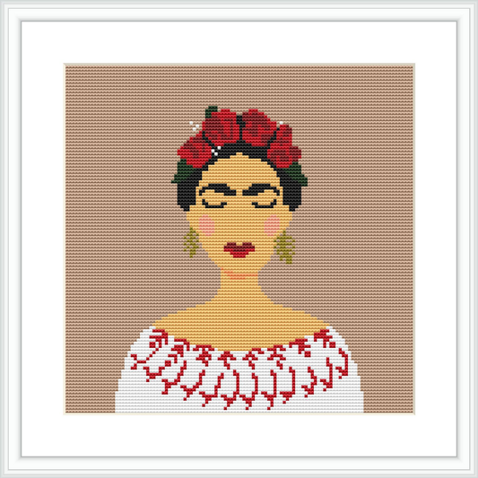 The image shows a cross stitch depiction of a female figure reminiscent of the artist Frida Kahlo, with a floral headdress and a white blouse. The pattern is centered on a beige canvas, framed in white.