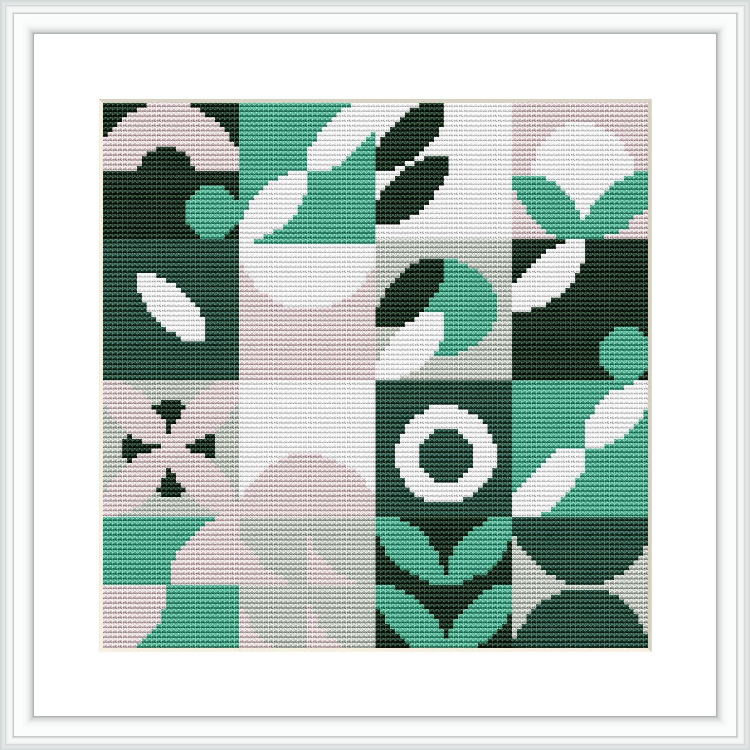 The image showcases a framed cross stitch design of geometric patterns, consisting of abstract shapes like circles, squares, and lines in a green, pink, black, white, and teal color scheme.