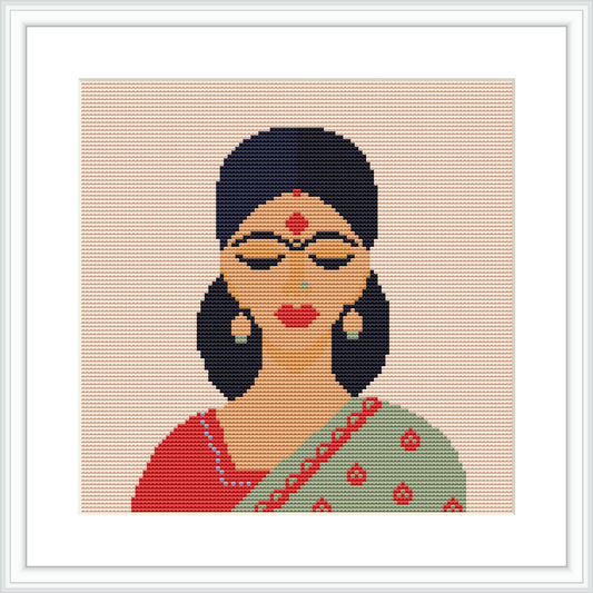 The cross stitch pattern displays an Indian woman's bust, featuring her face and upper body. She is wearing traditional Indian attire adorned with jewelry and has a decorative bindi on her forehead. The background is plain, highlighting the figure.