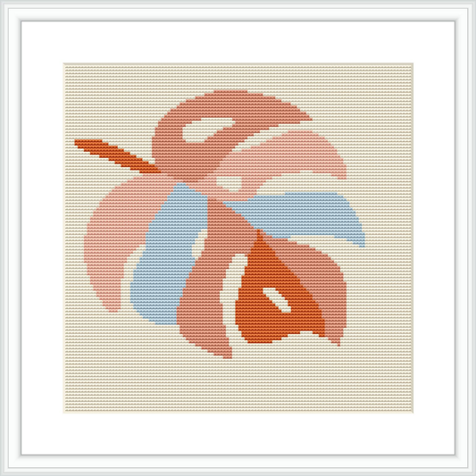 The image shows a framed cross stitch pattern featuring the stylized image of a monstera leaf. The leaf is rendered in shades of pink and blue on an ivory fabric background. The overall design is simple yet captures the essence of the tropical plant.