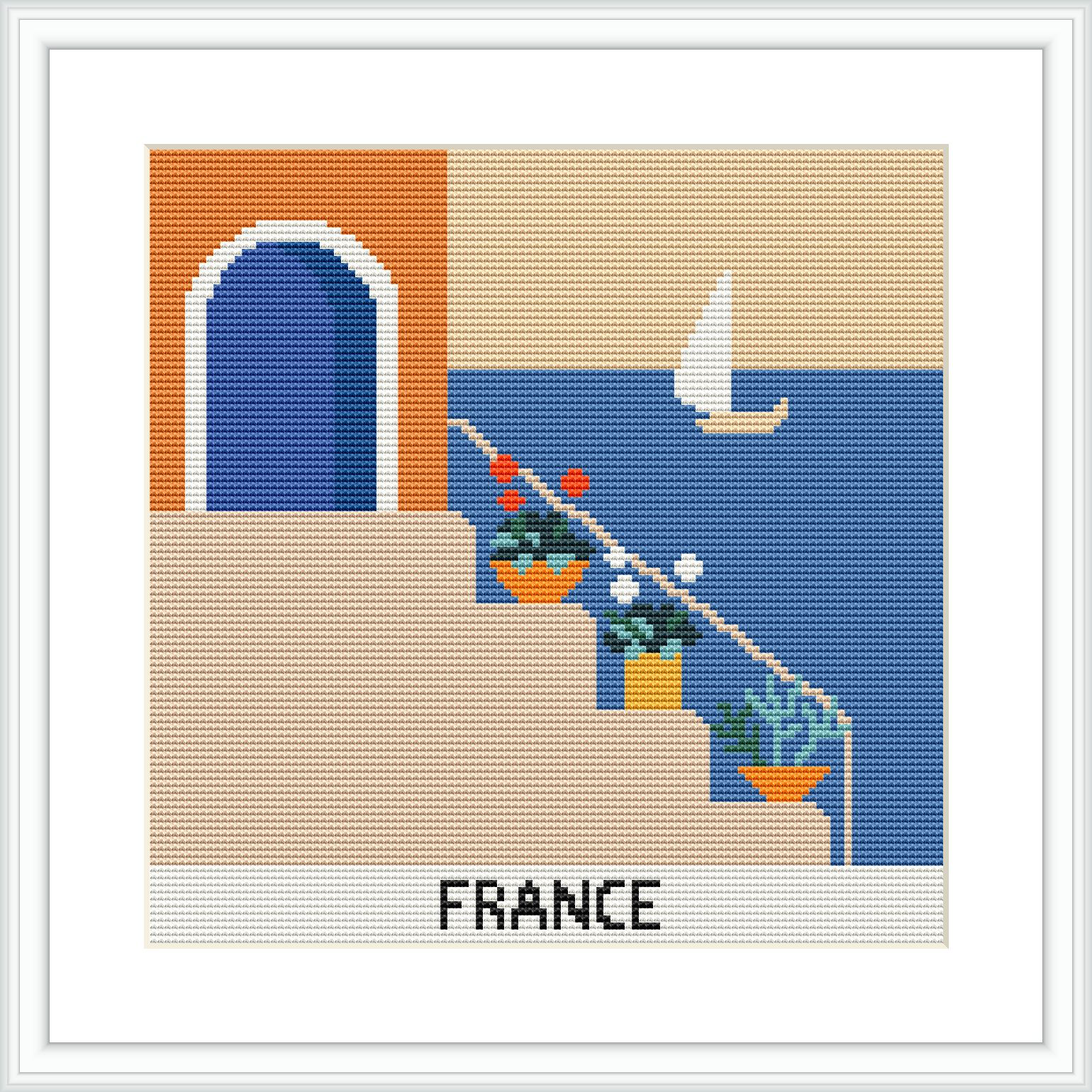The image is a cross stitch pattern depicting a coastal scene with a white sailboat on a blue sea, an archway in an orange wall, a flower pot with red flowers on a ledge, and the word 'FRANCE' stitched at the bottom.