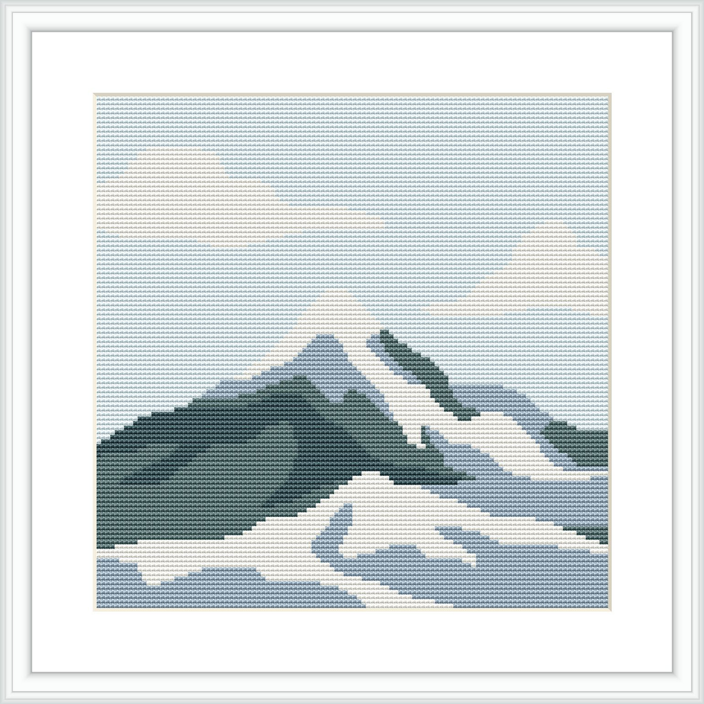 The image depicts a cross stitch pattern of a snow-capped mountain range with varying shades of white, blue, and green, against a pale sky with a white border framed within a square.
