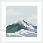The image depicts a cross stitch pattern of a snow-capped mountain range with varying shades of white, blue, and green, against a pale sky with a white border framed within a square.