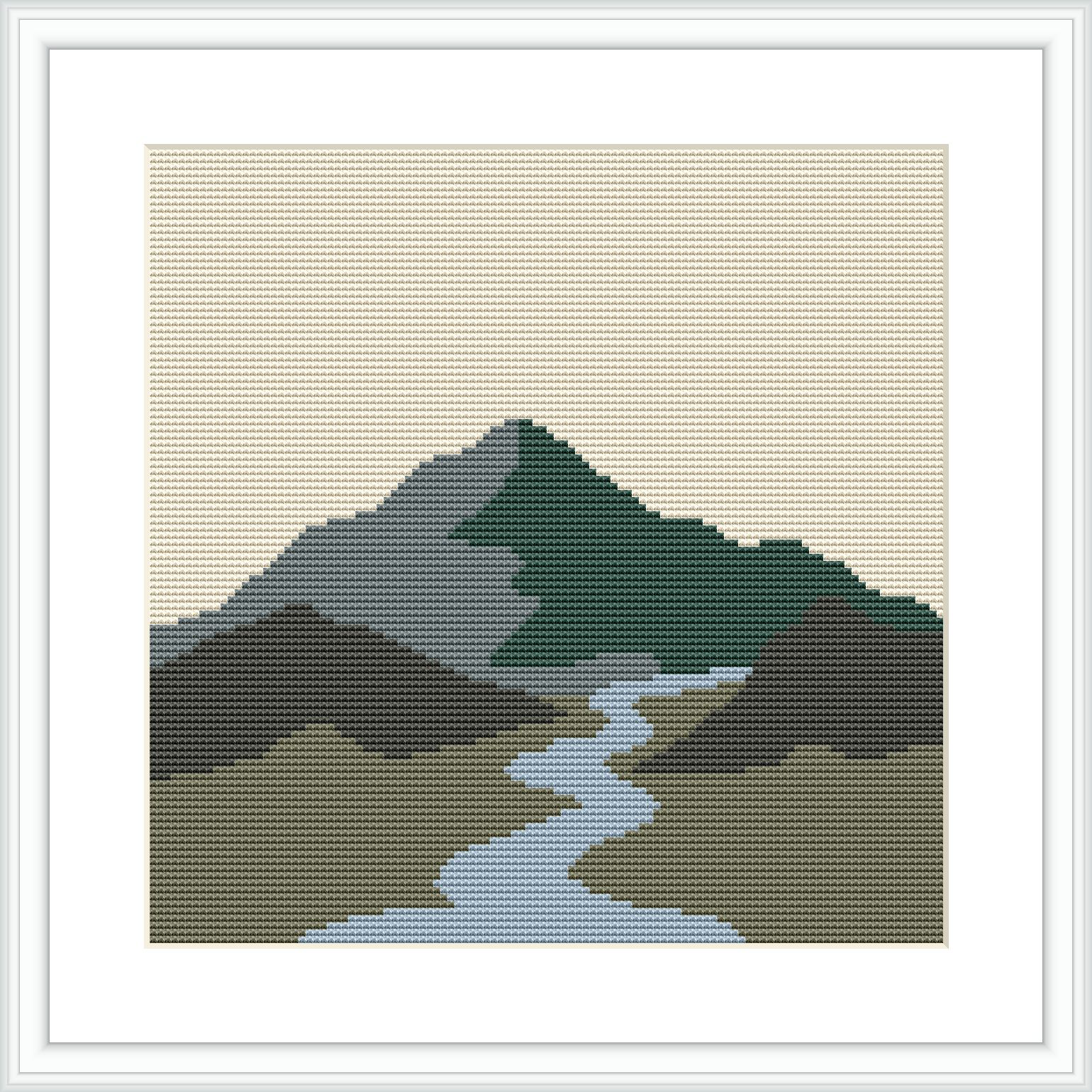 The image depicts a cross stitch pattern of a mountain landscape with a river running through it. The pattern includes variations of greens for the mountain, hues of blue and grey for the river, and a beige background that suggests an open sky.