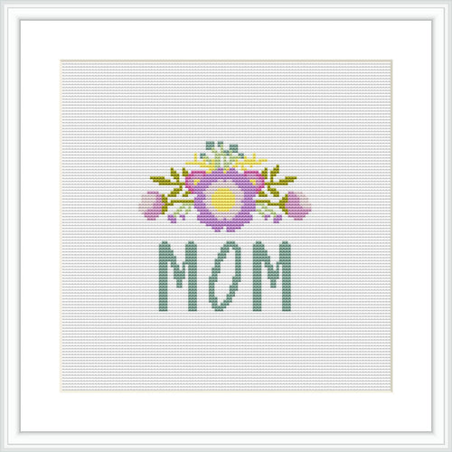 The image contains a cross stitch pattern featuring the word 'MOM' in green letters at the bottom, with a decorative floral arrangement above it showcasing a bouquet with purple and yellow accents on a white background.