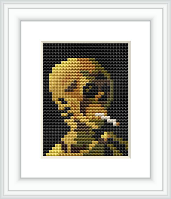 The image shows a framed cross stitch pattern depicting a skull with a lit cigarette in its mouth. The pattern is displayed against a dark background with a white border, giving it a framed appearance.