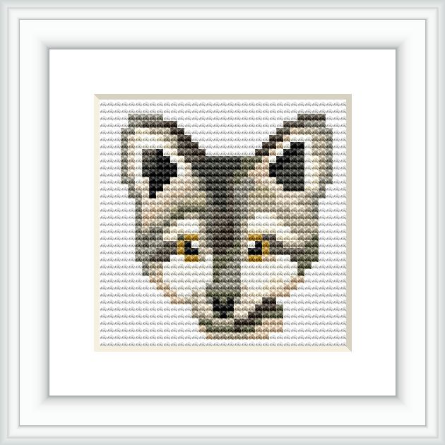 The image showcases a completed cross stitch pattern of a wolf's face framed and mounted on a wall. The wolf features different shades of grey, black and white, with striking yellow eyes. The pattern appears detailed despite its small size.