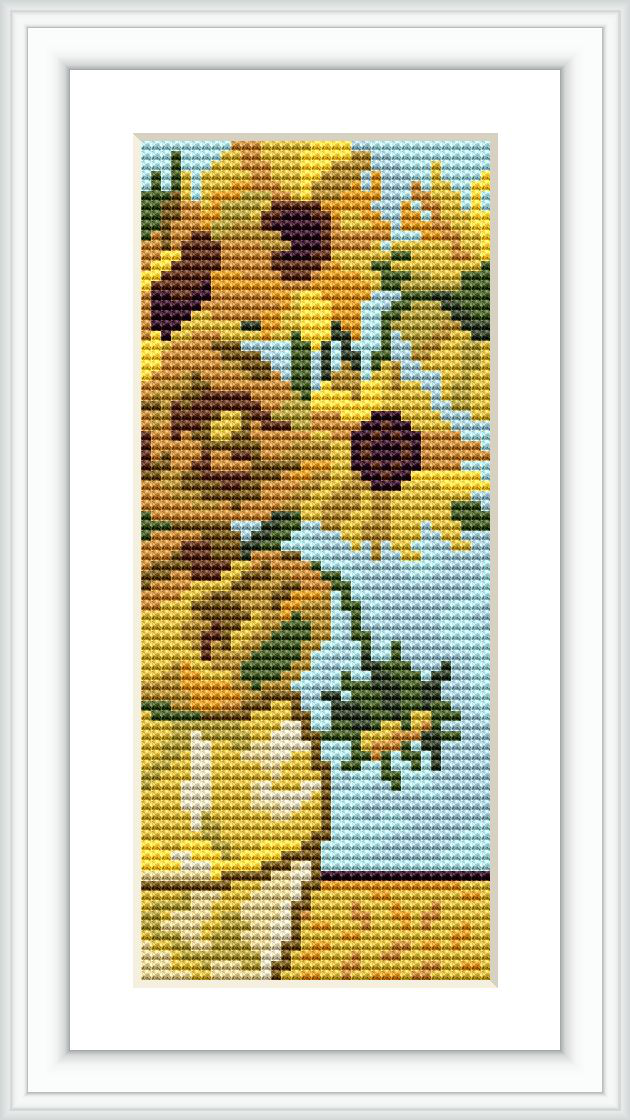 The image displays a framed cross stitch pattern depicting a vase of blooming sunflowers with a blue background.