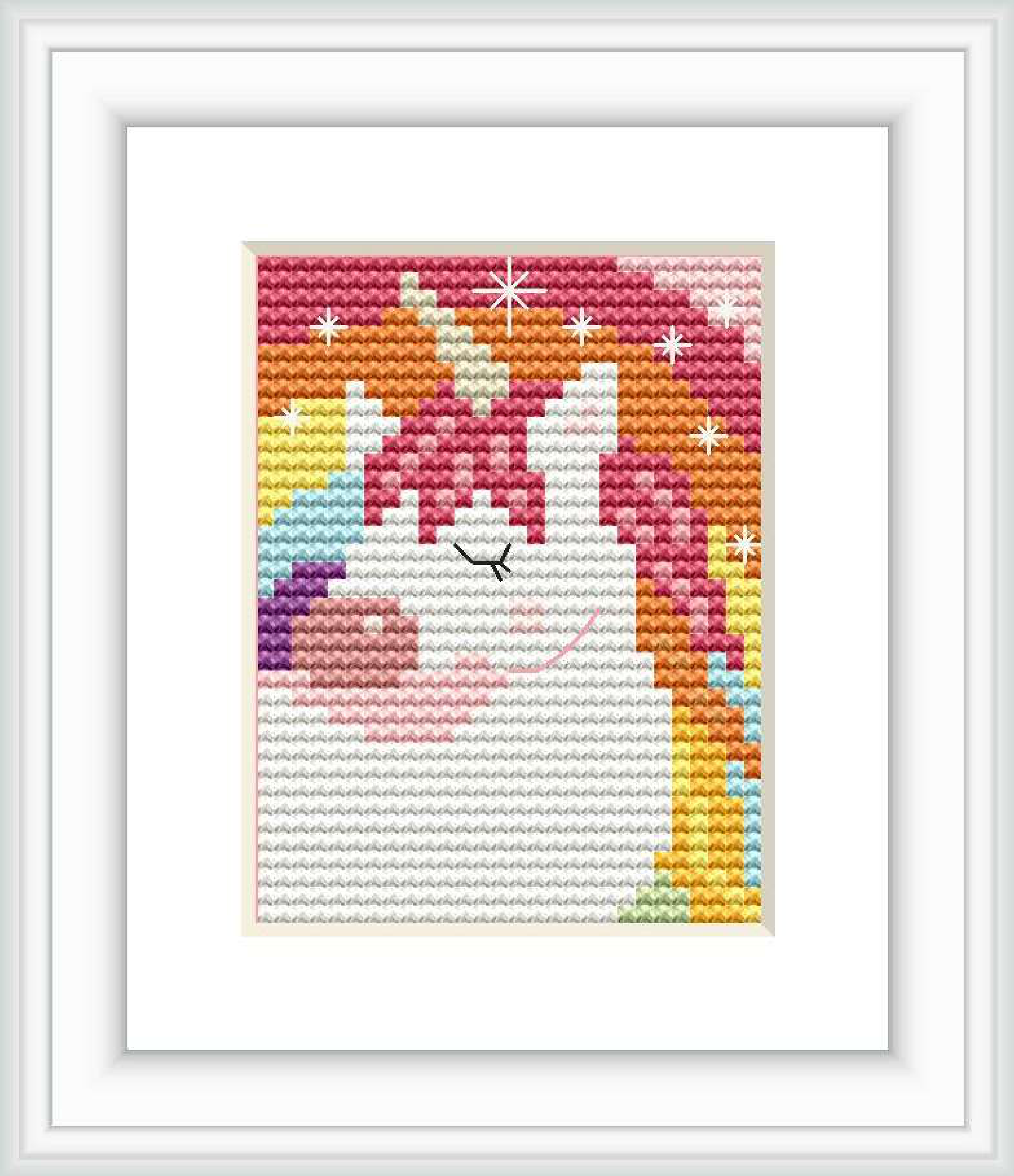 The image displays a framed cross stitch pattern of a stylized unicorn with a rainbow mane and stars around it. It is executed in bright and pastel colors against a plain background within a white frame.