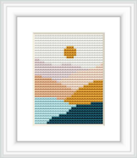 The pattern shows a stylized sunset with the sun above the horizon reflecting on water, using a gradient of colors to suggest dusk time.