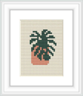The image presents a framed cross stitch design depicting a mini monstera plant with green leaves and a peach-colored pot, stitched on a neutral taupe fabric background.