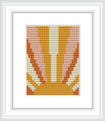 The image showcases a framed cross stitch pattern depicting an abstract sunrise design with segmented colors creating a gradient effect resembling the morning sun rising over the horizon.