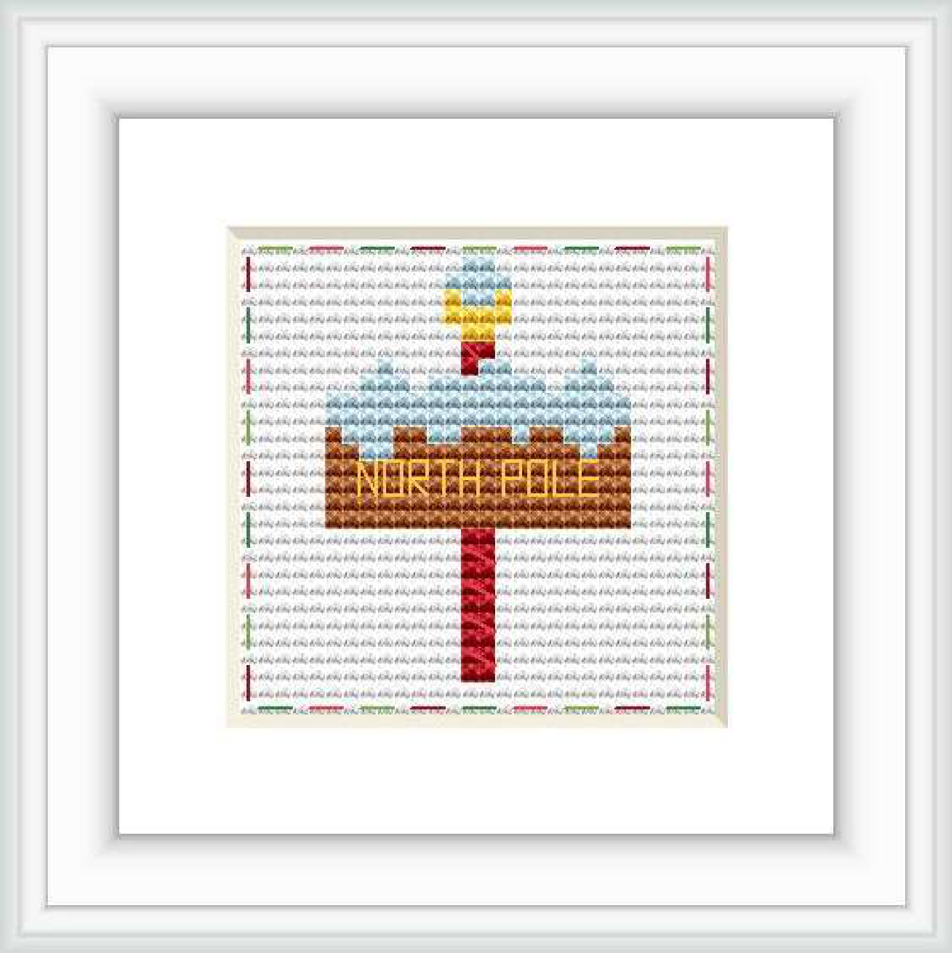 The image displays a cross stitch pattern with a festive North Pole signpost. The sign is centered on a white background with 'NORTH POLE' in golden letters. It is adorned with a red arrow and small Christmas decorations.