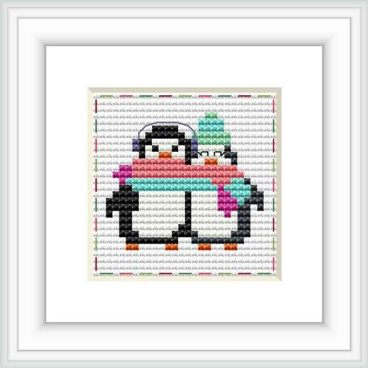 The image shows a cross stitch pattern of two penguins standing side by side with a multicolor pixelated background.