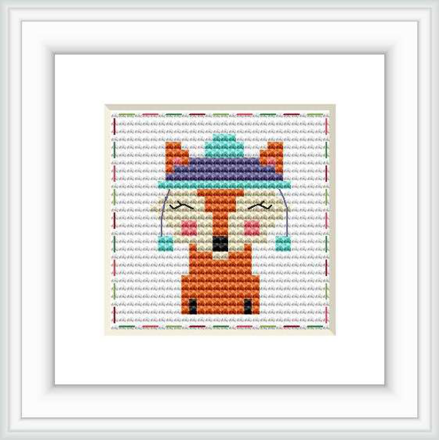 The image features a framed cross stitch pattern with a central depiction of a stylized fox set against a multicolored, stitch-textured background.