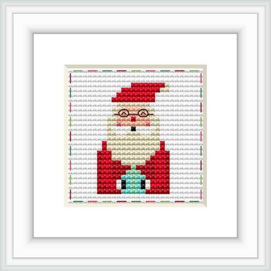 This image features a framed cross stitch pattern of a partial depiction of Santa Claus facing forward. The pattern is centered on a white background and showcases a square design with a red and white color theme.