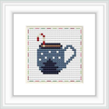 The image presents a framed cross stitch design with a motif of a steaming mug on a dual-tone background with a decorative border.