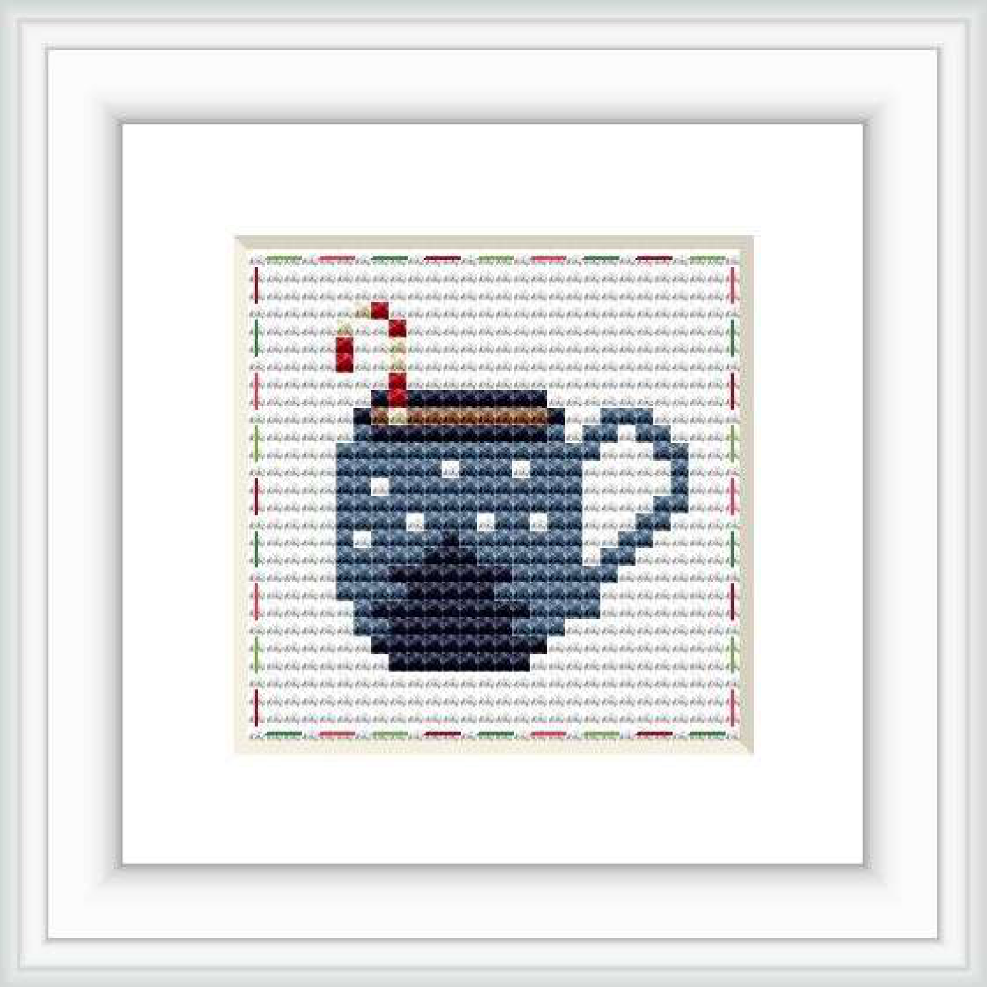 The image presents a framed cross stitch design with a motif of a steaming mug on a dual-tone background with a decorative border.